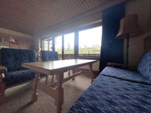 a room with a table and two chairs and a window at Chalet Villa Josi Superior Appartement 12 in Leutasch