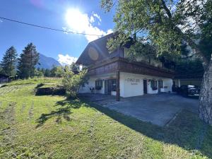 a building on a hill with a grassy field in front at Chalet Villa Josi Superior Appartement 12 in Leutasch