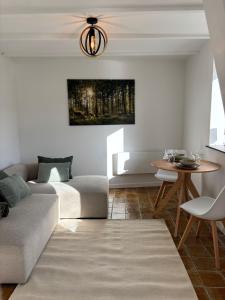 a living room with a couch and a table at Maison Aline in Hotton