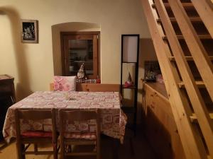 a dining room with a table and a staircase at La Casetta di Cri Morbegno in Morbegno +2 photos