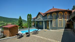 a large house with a swimming pool in front of it at Villa Requiem by Villas Guide in Bednja