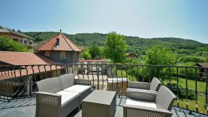 a balcony with chairs and a view of the mountains at Villa Requiem by Villas Guide in Bednja