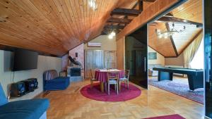 a living room and dining room with a ping pong table at Villa Requiem by Villas Guide in Bednja