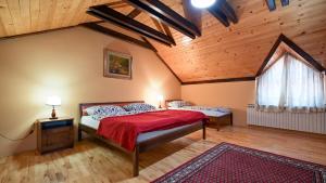 a bedroom with a bed and a wooden ceiling at Villa Requiem by Villas Guide in Bednja +30 photos