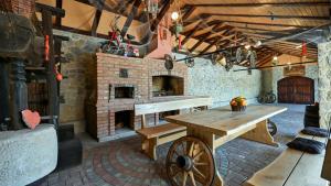 a room with a wooden table and a brick fireplace at Villa Requiem by Villas Guide in Bednja