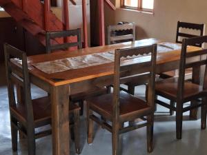 a wooden table and chairs with a wooden table and a table and chairs at Akasia - 333 in Hoedspruit