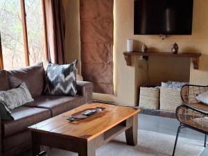 a living room with a couch and a coffee table at Akasia - 333 in Hoedspruit