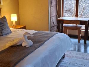 a bedroom with a bed with a stuffed animal on it at Akasia - 333 in Hoedspruit