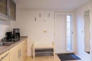 a kitchen with a sink and a counter top at Am Waldrand in Radis