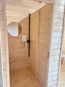 a sauna with a phone in a wooden wall at Zacisze Mazury in Kętrzyn +64 photos