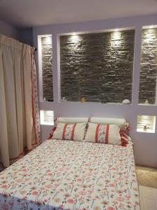a bedroom with a bed and two windows at Casa Olimpia - Mareri apartments in Poggi