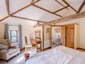 a bedroom with a bed and a desk and a chair at 2 Bed in Thetford oc-57886 in Saham Toney