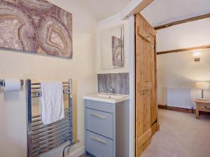 a bathroom with a sink and a mirror and a door at 2 Bed in Thetford oc-57886 in Saham Toney +30 photos