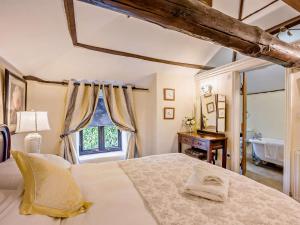 a bedroom with a large bed and a window at 2 Bed in Thetford oc-57885 in Saham Toney