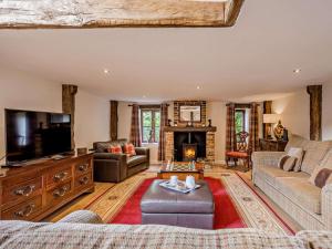 a living room with a couch and a fireplace at 2 Bed in Thetford oc-57885 in Saham Toney