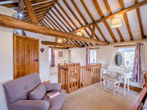 a living room with a couch and a table at 1 Bed in Thetford oc-57889 in Saham Toney