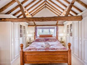 a bedroom with a bed with a wooden frame at 1 Bed in Thetford oc-57889 in Saham Toney