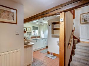a kitchen with a stairway leading to a kitchen with white cabinets at 1 Bed in Thetford oc-57889 in Saham Toney +25 photos