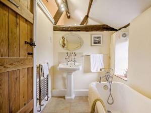 a bathroom with a white tub and a sink at 2 Bed in Thetford oc-57885 in Saham Toney +34 photos