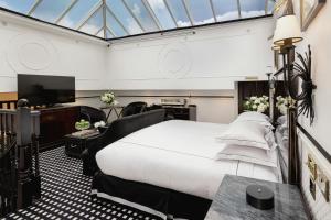 a bedroom with a large bed and a tv at 41 in London