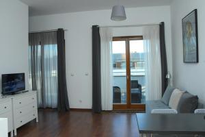 a living room with a couch and a tv at Platan 17 in Świnoujście