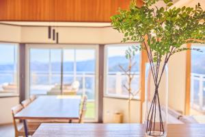 a table with a vase with a plant on it at プライベートリゾート清風 in Atami +14 photos