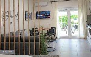 ein Wohnzimmer mit Sofa und einem Tisch mit Stühlen in der Unterkunft Dimegio in Alexandroupoli