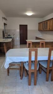 a kitchen with a table and chairs with a white table at Cozy rooms in Minde, Fatima in Minde