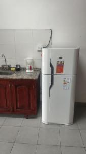 a white refrigerator in a kitchen with a counter at lo de Sandra 2 in Salta
