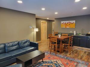 a living room with a couch and a table at Cold Brook Lodge - 2 and 3 Bedroom Luxury Apartments in Lake Placid