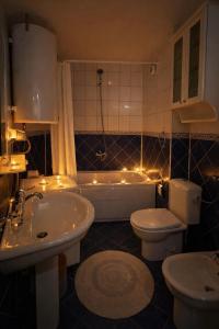 a bathroom with a tub and a toilet and a sink at Sim apartment in Skopje in Skopje