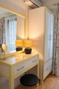 a dressing table with two lamps and a mirror at Sim apartment in Skopje in Skopje