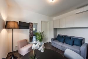 a living room with a couch and a table at Rapallo - Monolocale con piscina in Rapallo