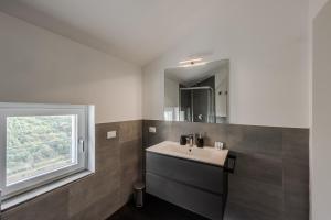 a bathroom with a sink and a window at Rapallo - Monolocale con piscina in Rapallo +61 photos