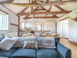 a living room with a blue couch and a kitchen at 3 Bed in Kings Lynn oc-88223 in Beeston +14 photos
