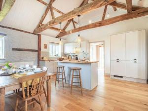 a kitchen and dining room with a wooden table and chairs at 3 Bed in Kings Lynn oc-88223 in Beeston
