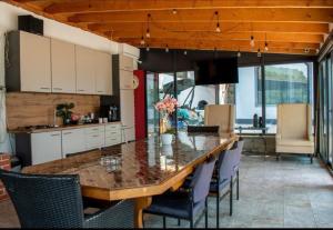 a kitchen with a large wooden table and chairs at Mala House in Orşova