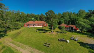 an aerial view of a large red house on a field at Haraldsgården Vandrarhem in Blidö