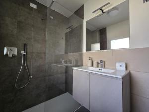 a bathroom with a shower and a sink and a mirror at Salionze Apartments in Salionze