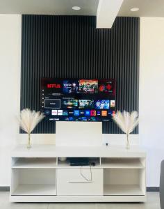 a flat screen tv on a wall in a room at CloudView Villa in Mahébourg