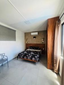a bedroom with a bed in the corner of a room at CloudView Villa in Mahébourg