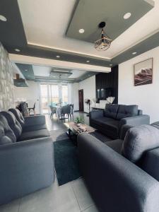 a living room with two couches and a table in it at CloudView Villa in Mahébourg