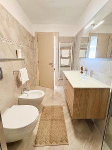a bathroom with a toilet and a sink and a tub at Sunrise apartament in Monterosso al Mare +24 photos