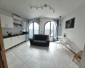 a living room with a couch and a kitchen at Holiopolis in St. Paul's Bay