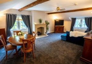 a living room with a table and a couch at Santo's Higham Farm Hotel in Alfreton