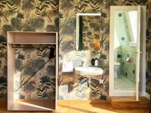 a bathroom with a sink and a mirror at Hotel Beau Séjour Lucerne in Lucerne +68 photos