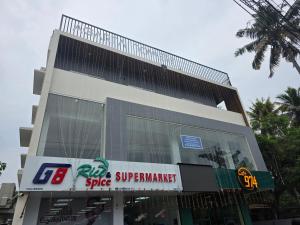 a building with a sign in front of it at Atharva homes at Vallikavu Amritapuri in Perinād