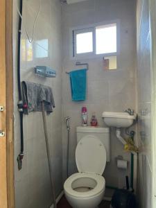 a small bathroom with a toilet and a sink at El quincho in San Pedro +9 photos