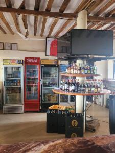 a store with two soda machines and a counter with drinks at KimyaKimya Pub & Lodge in Dar es Salaam