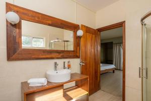 a bathroom with a sink and a mirror at Authentic Nest in La Gaulette